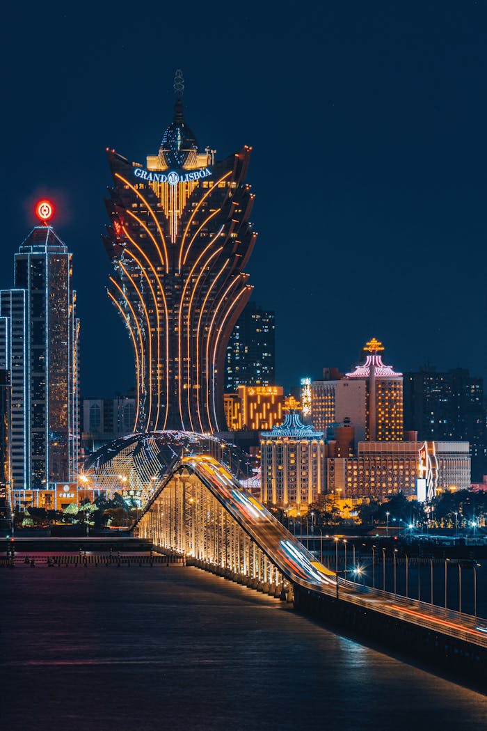 Stunning night view of Macau skyline featuring the iconic Grand Lisboa hotel and illuminated city lights.